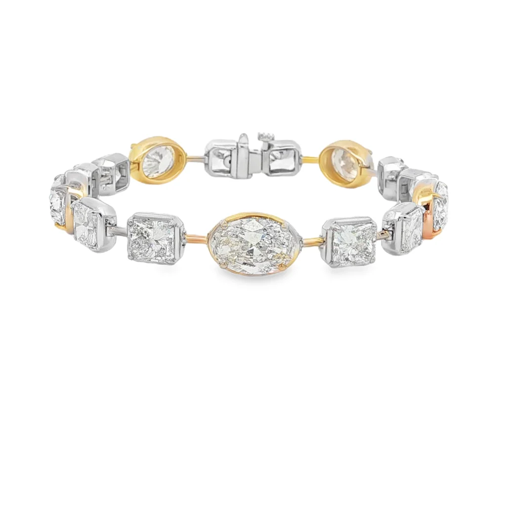 Elevate your wrist with this exquisite two-tone tennis bracelet. Meticulously crafted in radiant yellow gold, this elegant bracelet showcases brilliant-cut colorless diamonds in square and oval shapes. A timeless fusion of classic design and unparalleled sparkle, it embodies enduring sophistication. This alluring diamond bracelet is the ultimate treasure.