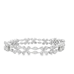 Indulge in the allure of this exquisite platinum tennis bracelet, featuring meticulously set pear cut diamonds. The brilliant cutting style enhances the inherent sparkle and fire of each diamond, creating a radiant display of light. This bracelet exemplifies timeless elegance and sophistication, perfect for adding a touch of luxury to any ensemble.