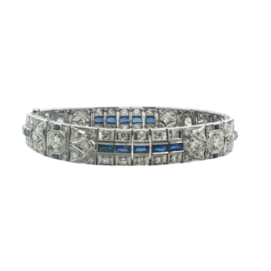 Capture timeless elegance with this platinum tennis bracelet. Featuring deeply saturated blue square-cut sapphires in step cut, contrasted by brilliant round diamonds. Its elaborate art deco design and precision detailing create a sophisticated appeal. A vintage-inspired masterpiece of timeless style, that's perfect for adding a touch of refined sparkle to any attire. 
