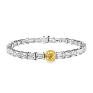 Elevate your wrist with this sophisticated white gold tennis bracelet. The bracelet features a series of step-cut emerald shape diamonds, accentuated by a central 1.50 fancy intense yellow diamond. The craftsmanship is evident in the bracelet's symmetry and high polish, resulting in a remarkable piece of fine jewelry. 18KWG , 14.80gr, 29 st, 15.85 ct, IJ VS EM, 1.51 CU FIY GIA