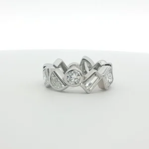This exquisite 14k white gold eternity ring showcases a continuous band of multi-shaped diamonds, meticulously set to ensure maximum light reflection. Each diamond features exceptional clarity and a high-grade polish, creating a seamless stream of radiance. The timeless composition and symmetrical arrangement highlight the precision of the brilliant cutting style. Designed with a sleek profile, this piece serves as a sophisticated symbol of everlasting elegance, perfect for stacking or as a standalone statement.